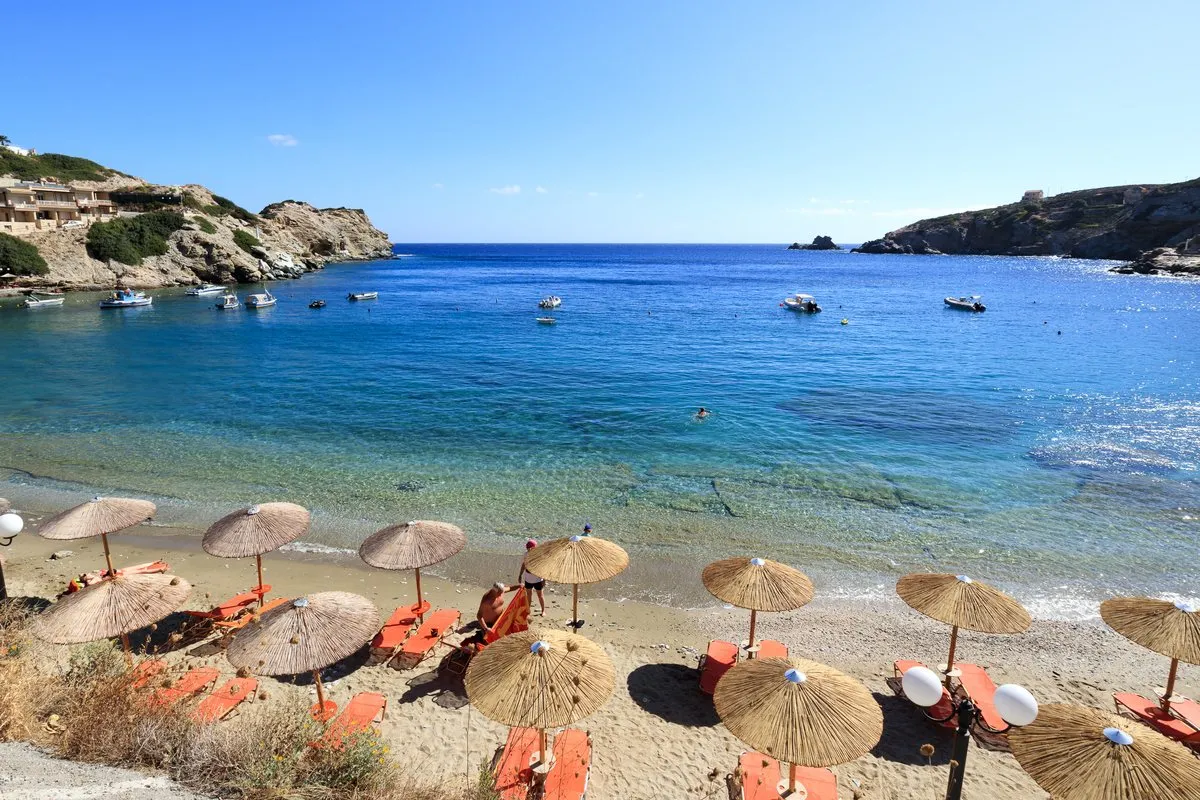 Sunbed rows and straw umbrellas packed onto the sand at Agia Pelagia