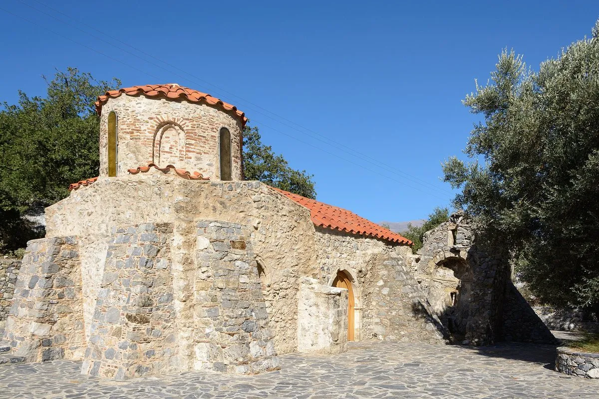 The drum-domed chapel of Agios Ioannis Theologos among olives
