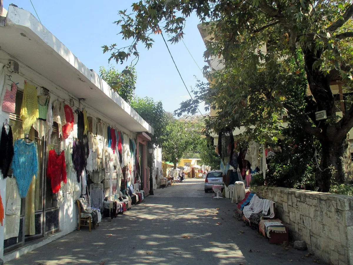 Woven textiles hung along an Anogia lane
