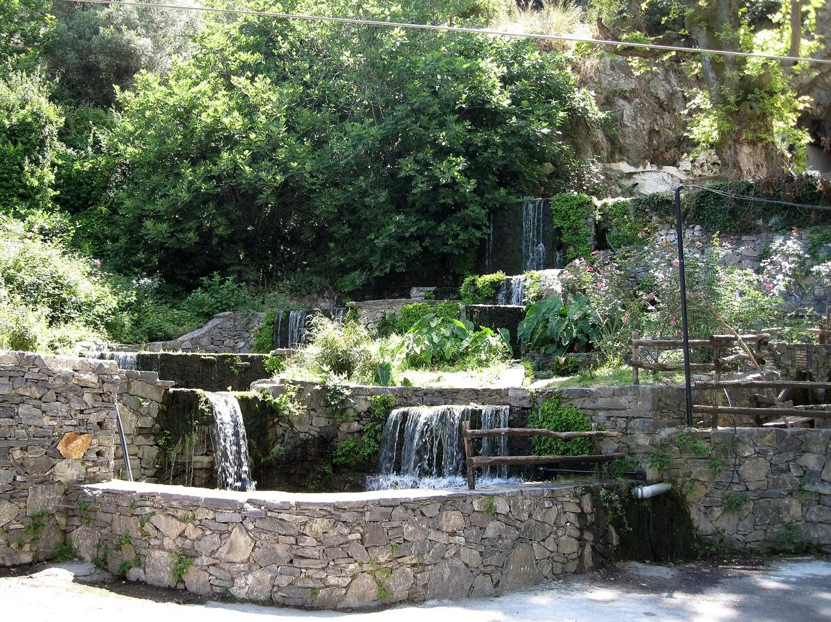 Small waterfalls and stone channels running through the springs at Argyroupoli