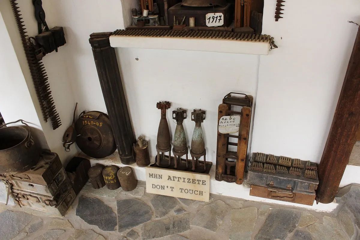 Mortar rounds and wartime objects arranged on a shelf inside the museum