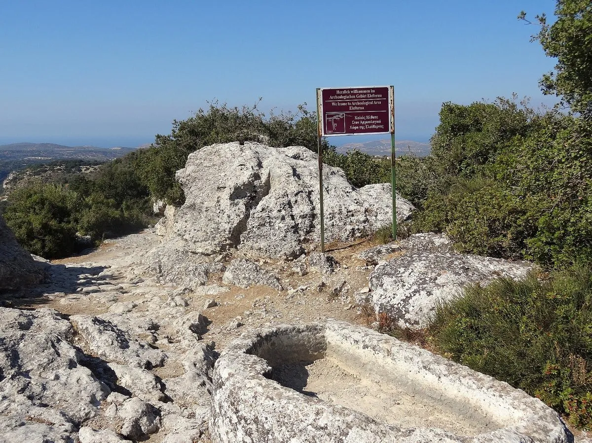 The rocky acropolis ridge at Eleftherna with an information sign
