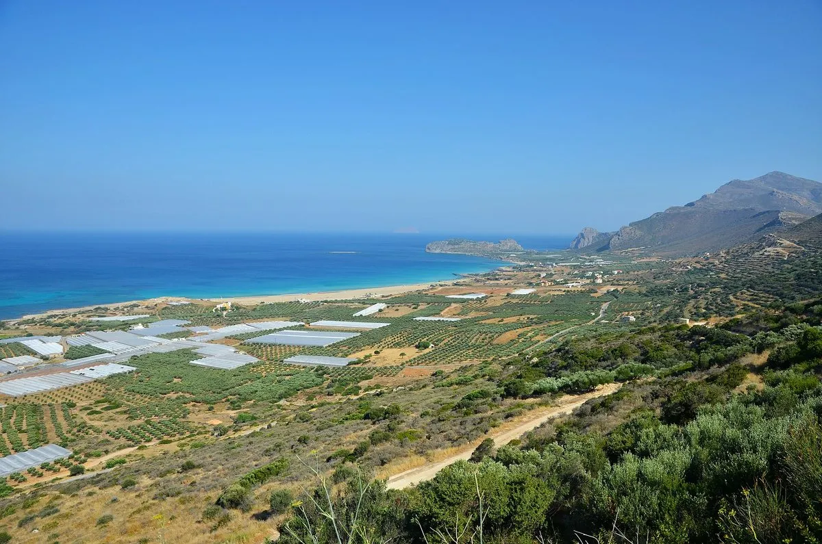 The full sweep of Falassarna: beach, dunes and greenhouse plain