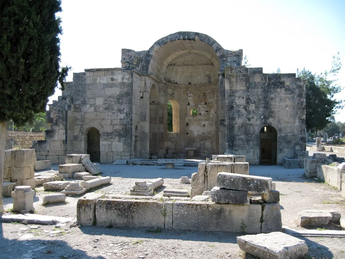 The roofless stone basilica of Agios Titos at Gortyna, its high walls and arched doorways standing among scattered blocks