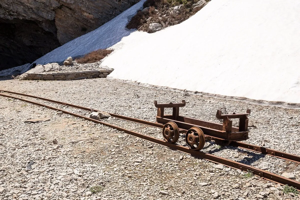 An excavation trolley on rails outside the Idaean cave