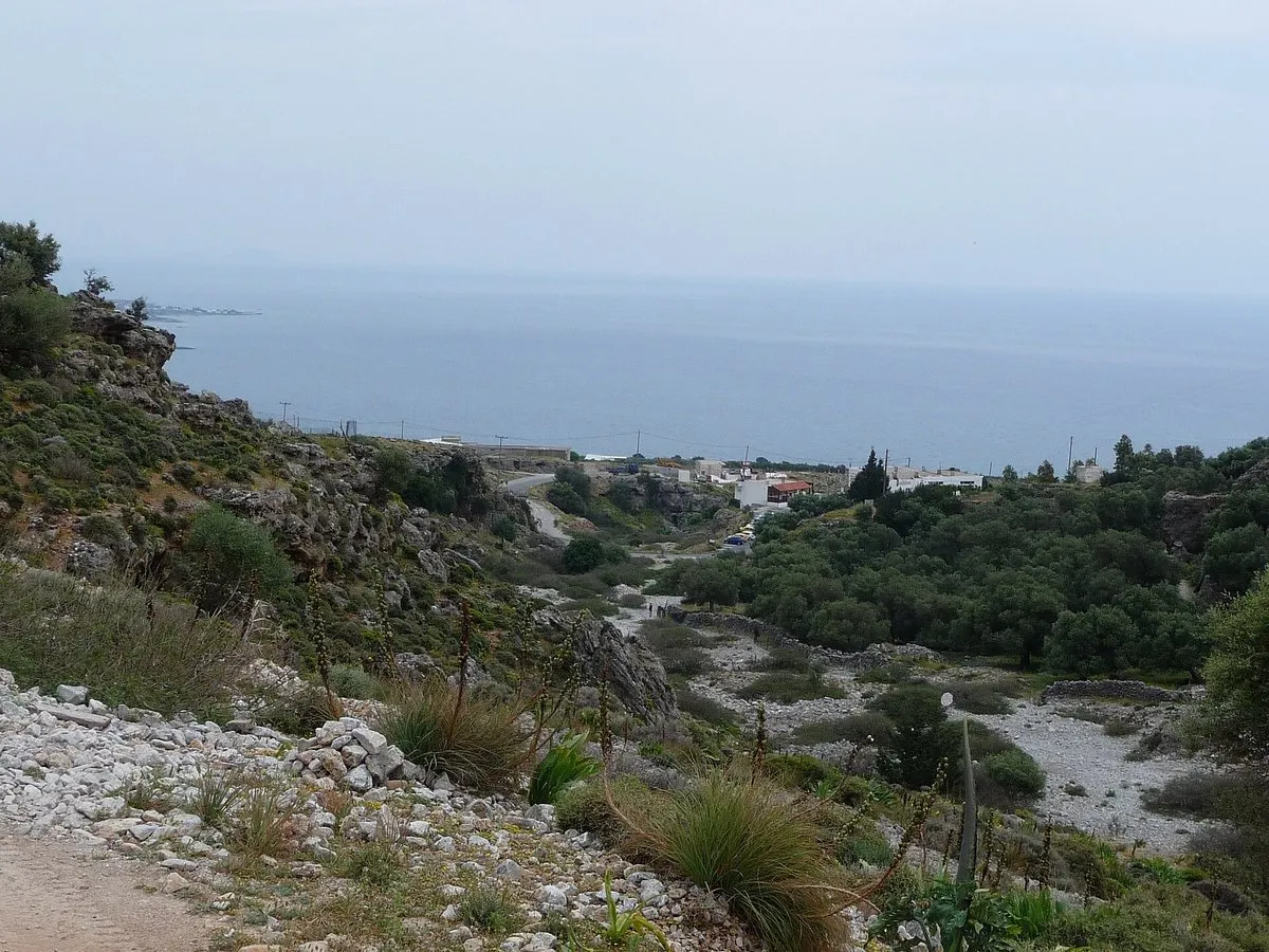 The lower end of Imbros Gorge opening out, with the village below and the Libyan Sea filling the horizon