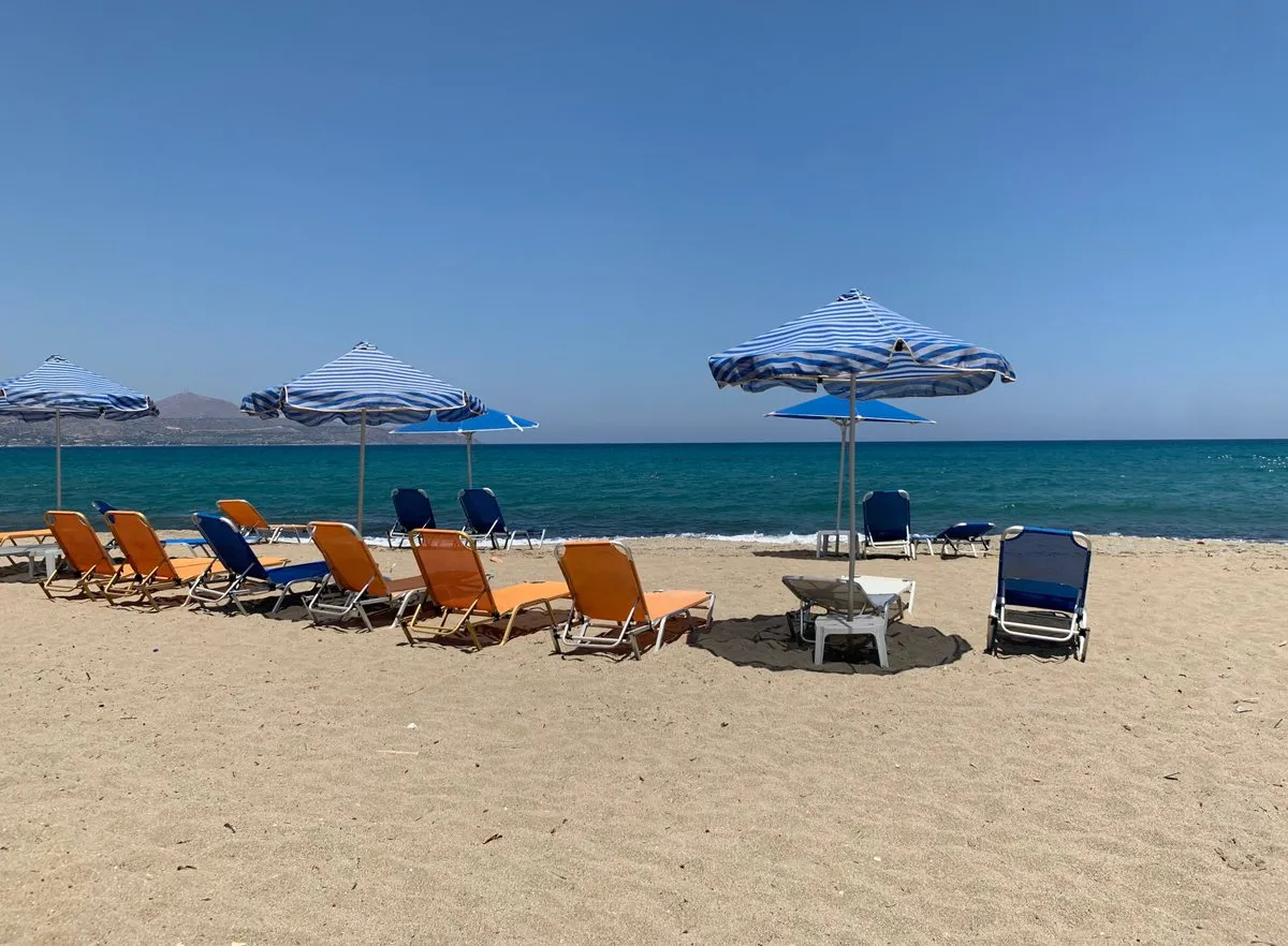 Transats et parasols sur le sable à Kalyves