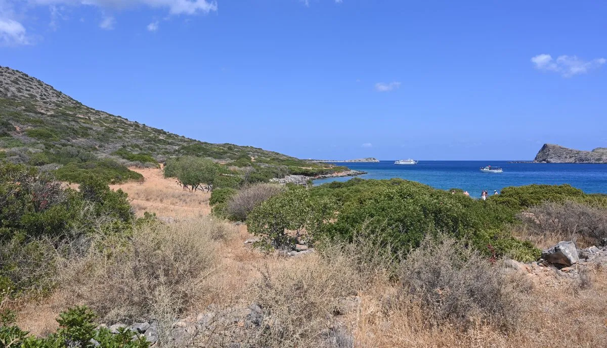 The bare, pine-tufted spur of the Kolokytha peninsula with the island offshore