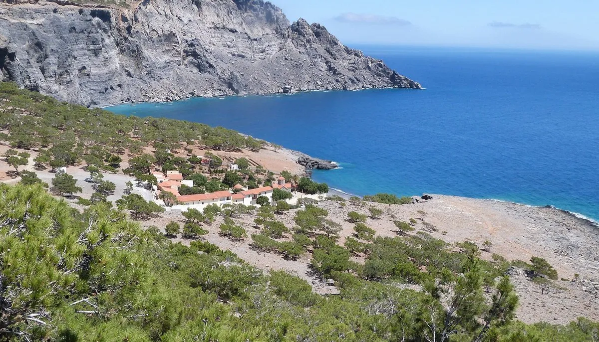 The Koudoumas monastery grounds above the pebble shore
