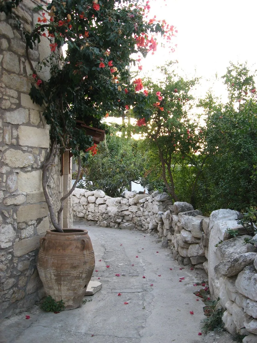 A whitewashed lane in Margarites with a great pithari
