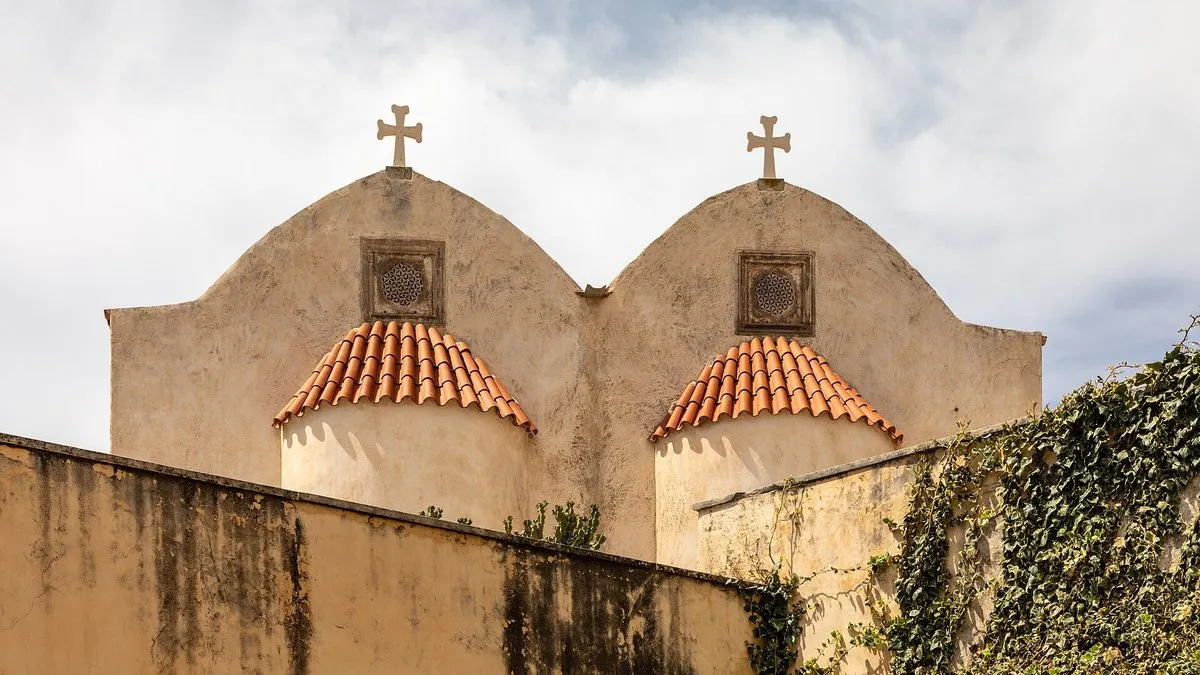 The twin bell gables of Preveli Monastery against the sky