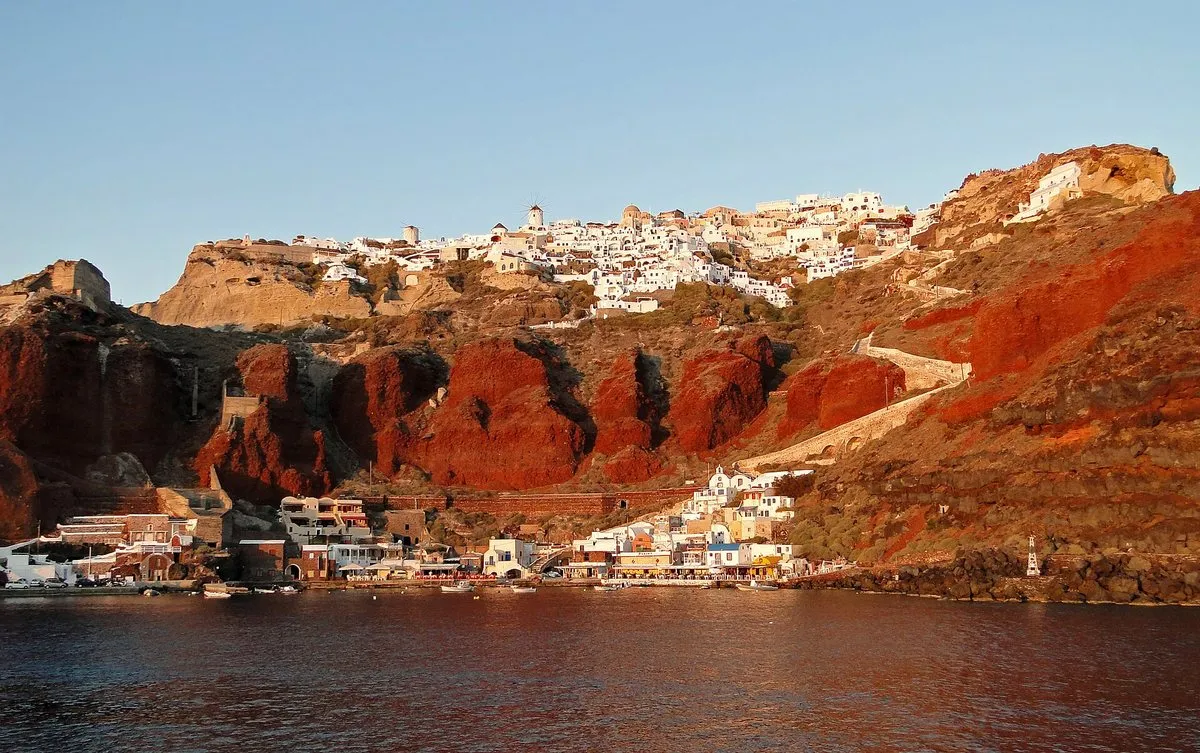 The red cliffs and village of Armeni below Oia, seen from the water