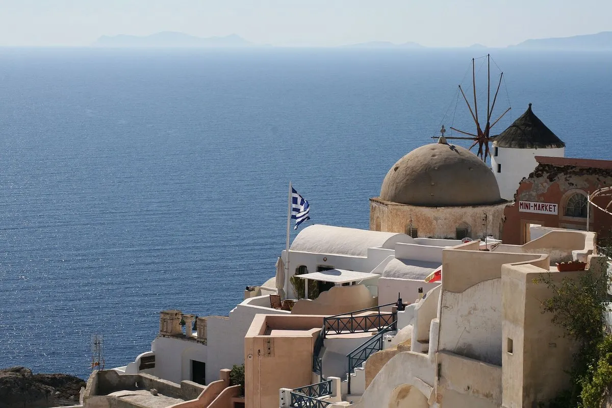 Oia on Santorini, whitewashed houses and a windmill above the caldera