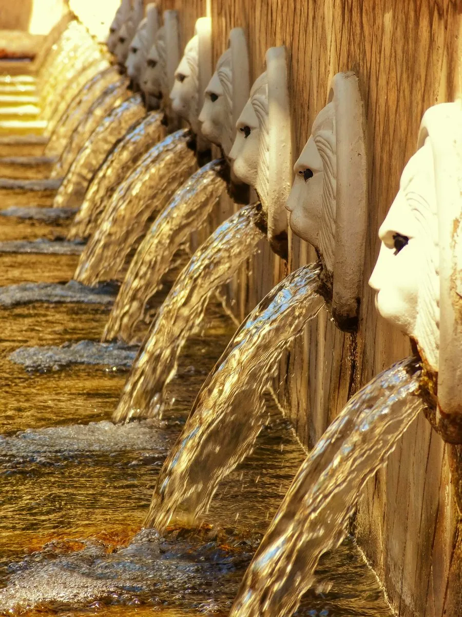 The row of Venetian lion-head spouts at Spili