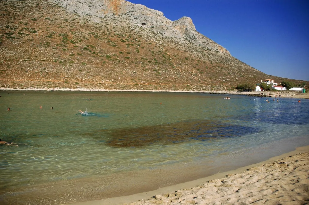 The near-circular bay at Stavros under its bare mountain, with clear shallow water