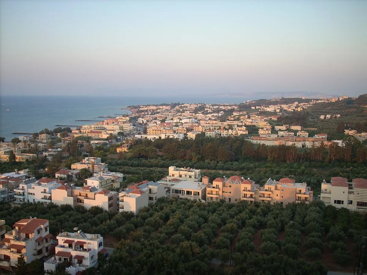 The resort strip and its olive groves from the Platanias hill