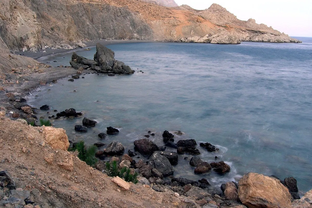 Dark pebbles and rock stacks on the shore