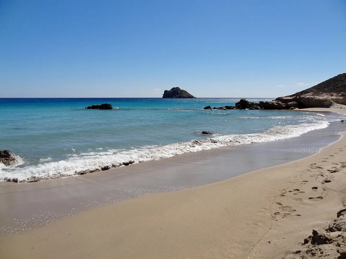 An empty curve of sand holding only footprints